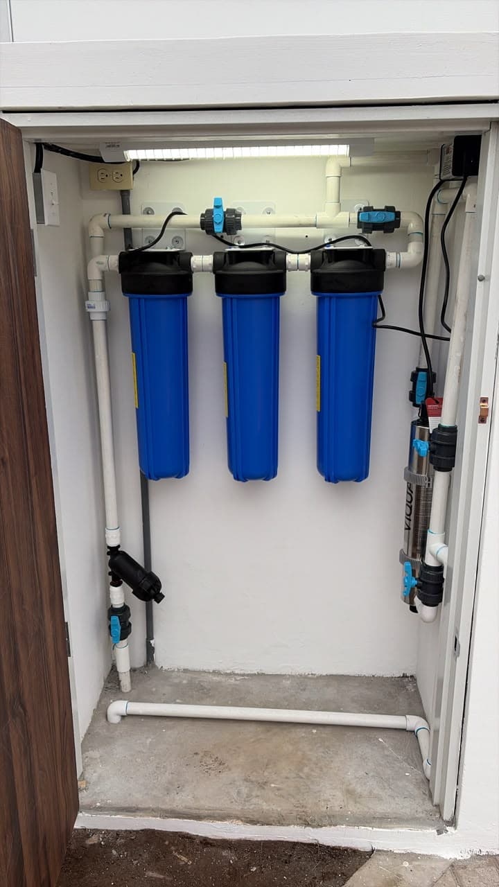 Three-stage water filtration system with a UV purifier installed inside a purpose-built cabinet